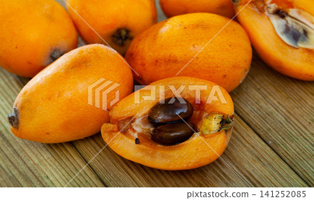 Loquat on wooden table Loquat on wooden table 141252085