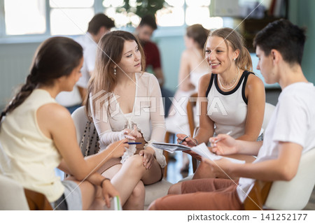 Students have divided into two teams and are discussing tactics of debate or competition Students have divided into two teams and are discussing tactics of debate or competition 141252177