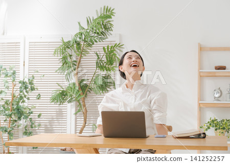 A woman working remotely with a smile 141252257