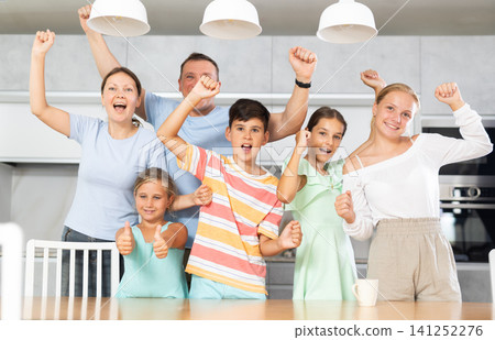 Portrait of happy family, children and parents scream with joy and hold their hands up 141252276
