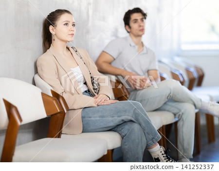 Girl applicant waiting for interview in queue of people Girl applicant waiting for interview in queue of people 141252337