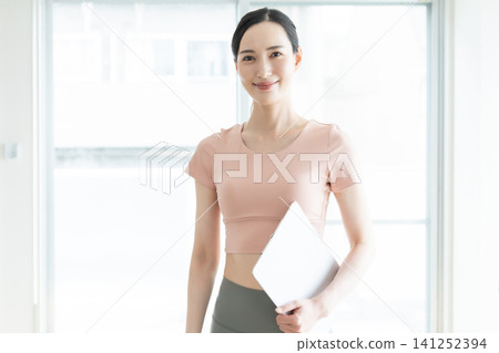 Female Pilates Instructor Female Pilates Instructor 141252394