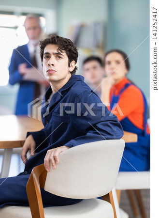 Mature male speaker address to young workers, man delivers lecture. Mature male speaker address to young workers, man delivers lecture. 141252417