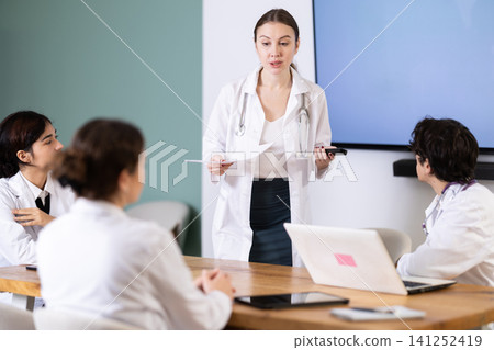 Young female doctor leading medical meeting in office Young female doctor leading medical meeting in office 141252419