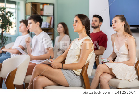 At meeting room during lecture, visitors listen to teacher 141252564