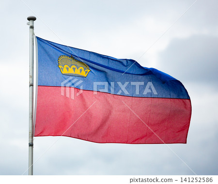 National flag of Principality of Liechtenstein on sky background National flag of Principality of Liechtenstein on sky background 141252586