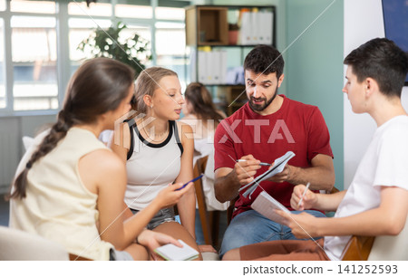 Two teams debating and discussing in classroom circle arrangement Two teams debating and discussing in classroom circle arrangement 141252593