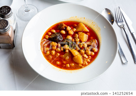 Chickpea soup with chorizo served on table Chickpea soup with chorizo served on table 141252654