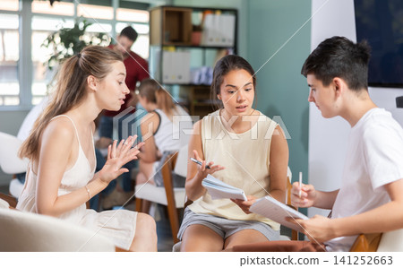 Students have divided into two teams and discussing tactics of debate under teacher guidance 141252663