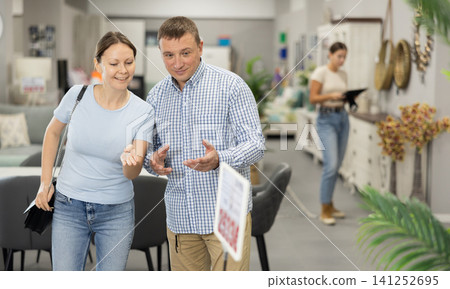 Couple visiting store in search of new furnishings for apartment Couple visiting store in search of new furnishings for apartment 141252695