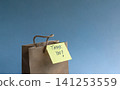 Thank you note attach to a brown gift bag 141253559