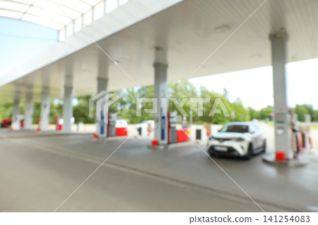 Cars line up at a refueling station under clear skies Cars line up at a refueling station under clear skies 141254083