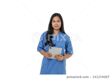 Doctor in blue scrubs holding a tablet, isolated on white, PNG 141254087