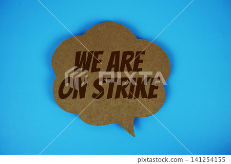 We Are On Strike text with speech bubble on blue background We Are On Strike text with speech bubble on blue background 141254155