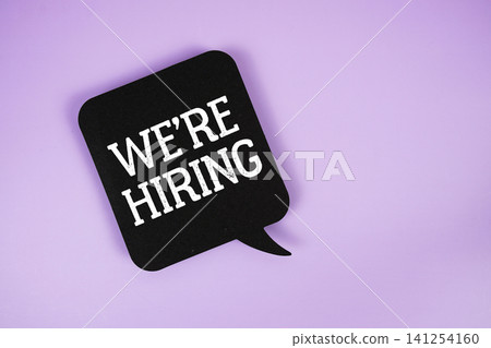 We're Hiring text with speech bubble on purple background We're Hiring text with speech bubble on purple background 141254160