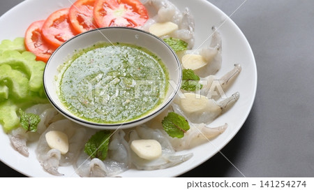 shrimp in fish sauce with Thai spicy seafood dipping sauce on white plate shrimp in fish sauce with Thai spicy seafood dipping sauce on white plate 141254274