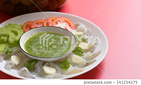 shrimp in fish sauce with Thai spicy seafood dipping sauce on white plate and umeshu 141254275