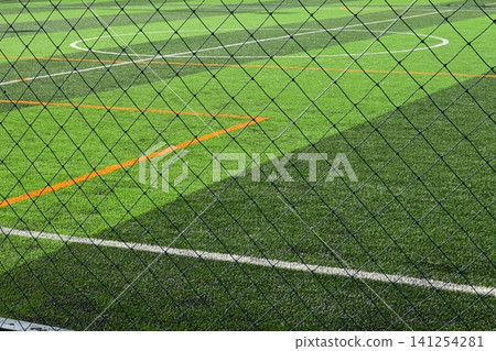 artificial green grass background with black net artificial green grass background with black net 141254281