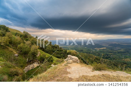 View of the mountains and Kislovodsk from the observation decks of the Kislovodsk Park. Evening sunset over the mountains of Kislovodsk. View of the mountains and Kislovodsk from the observation decks of the Kislovodsk Park. Evening sunset over the mountains of Kislovodsk. 141254356