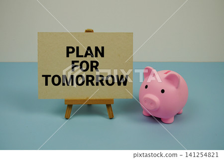 Plan for Tomorrow text written on paper card with easel and piggy bank Plan for Tomorrow text written on paper card with easel and piggy bank 141254821