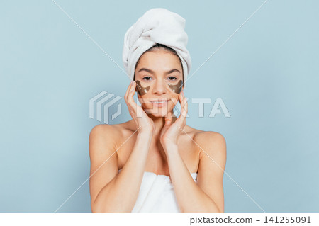 Smiling woman with gold eye masks Smiling woman with gold eye masks 141255091