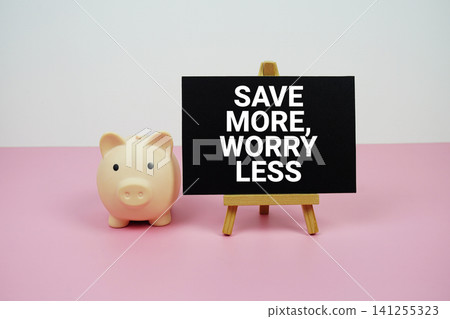 Save More, Worry Less text written on paper card with easel and piggy bank Save More, Worry Less text written on paper card with easel and piggy bank 141255323