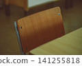 Empty Wooden School Chair in a Quiet Classroom 141255818