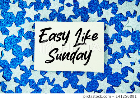 Easy Like Sunday text written on paper card with star glitter on blue background Easy Like Sunday text written on paper card with star glitter on blue background 141256891