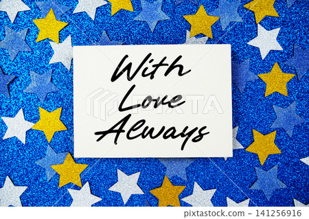 With Love Always text written on paper card with star glitter on blue background With Love Always text written on paper card with star glitter on blue background 141256916