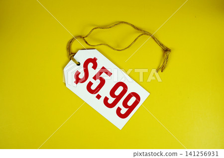 Price tag with "$5.99" is placed on yellow background Price tag with "$5.99" is placed on yellow background 141256931