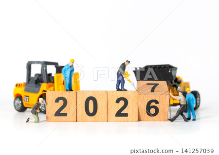Miniature Construction Workers Changing 2026 to 2027 with Wooden Blocks and Heavy Machinery Miniature Construction Workers Changing 2026 to 2027 with Wooden Blocks and Heavy Machinery 141257039
