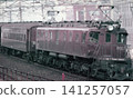 A passenger train pulled by an EF57 electric locomotive (No. 3) running near Nishi-Nippori Station during the Japanese National Railways era. 141257057