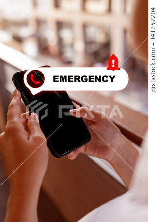Person using smartphone to make emergency call during day in busy urban location Person using smartphone to make emergency call during day in busy urban location 141257204