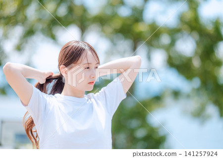 特寫鏡頭:一位女士正在綁頭髮 特寫鏡頭:一位女士正在綁頭髮 141257924