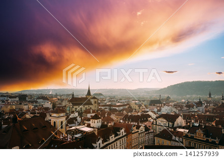 Dark dramatic clouds over the historic skyline of Prague at sunset. Dark dramatic clouds over the historic skyline of Prague at sunset. 141257939