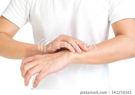 The man touches the wrist and thumb. He squeezes the knuckle of the thumb and wrist. He suffered a tendon injury, arthritis in his wrist, and de quervain's disease. The man touches the wrist and thumb. He squeezes the knuckle of the thumb and wrist. He suffered a tendon injury, arthritis in his wrist, and de quervain's disease. 141258161