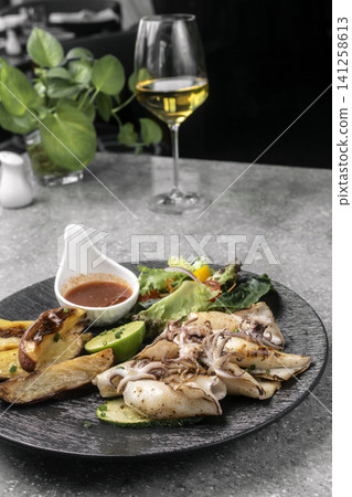 mediterranean grilled fresh squid meal on restaurant table mediterranean grilled fresh squid meal on restaurant table 141258613