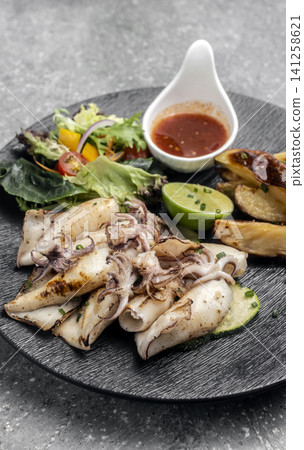 mediterranean grilled fresh squid meal on restaurant table mediterranean grilled fresh squid meal on restaurant table 141258621