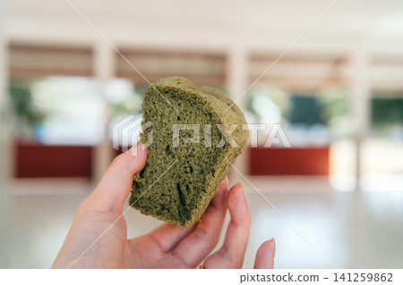 A hand holding a chiffon cake 141259862