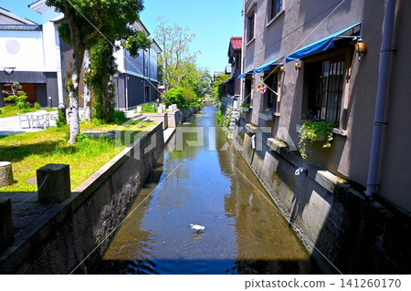 Old townscape with a river Old townscape with a river 141260170
