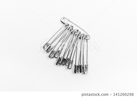 Pins or paper clips to remind you of objects on a white background Pins or paper clips to remind you of objects on a white background 141260298