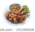 Crispy fried pork with spicy Asian dipping sauce, featuring golden texture and bold flavors. Perfect for Asian cuisine, street food, comfort food on  white background. 141260926