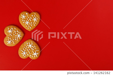 beautiful hand-baked cookies in the shape of a heart on a red background beautiful hand-baked cookies in the shape of a heart on a red background 141262162