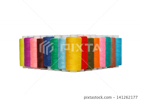 multi-colored spools of sewing thread on a white background multi-colored spools of sewing thread on a white background 141262177