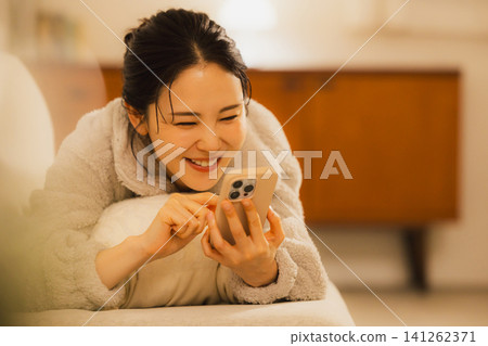 A woman watching a night smartphone A woman watching a night smartphone 141262371