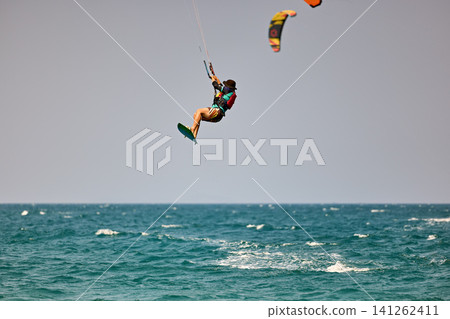 Nha Trang, Khanh Hoa, Vietnam - April 5, 2026: Kitesurfer Performing High Jump Above Waves in Nha Trang Nha Trang, Khanh Hoa, Vietnam - April 5, 2026: Kitesurfer Performing High Jump Above Waves in Nha Trang 141262411