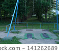 An empty swing in a park at dusk 141262689