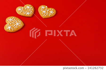 beautiful hand-baked cookies in the shape of a heart on a red background beautiful hand-baked cookies in the shape of a heart on a red background 141262732