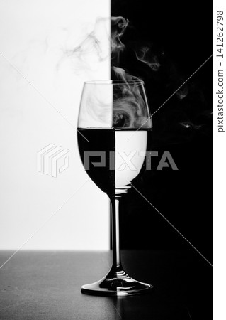 a glass of water and smoke on a black and white background a glass of water and smoke on a black and white background 141262798