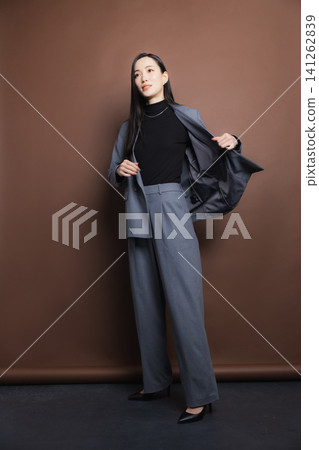 A woman in a stylish suit A woman in a stylish suit 141262839